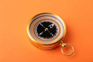 One compass on orange background. Navigation equipment © New Africa