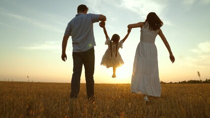 Cute family having fun at sunset, holding hands. Together mom mother daughter kid child dad father...