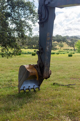 Machinery in harmony with nature: Excavator in the pasture.