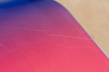 Battle Worn: Detailed Image of a Worn-Out Snowboard Surface: Capturing the Scratches on a...