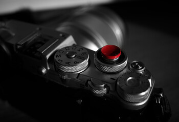 Retro looking photo camera with red shutter release button