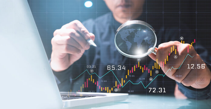 Businessman using magnifying glass to Data analysis Business finance and investment, graph growth chart, stock market report and forex, business growth, work from home or small business