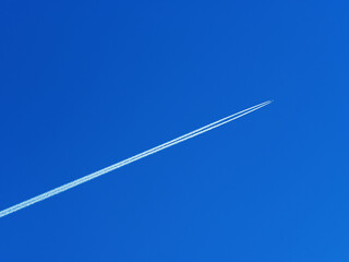 Fuel trace of jet in clean blue sky backdrop