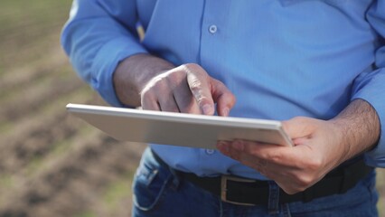Businessman digital agricultural farmer with tablet. Hands male professional using tablet. Creation...