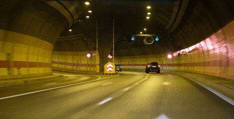 turn lane in tunnel, car traffic in the tunnel, lighted car tunnel