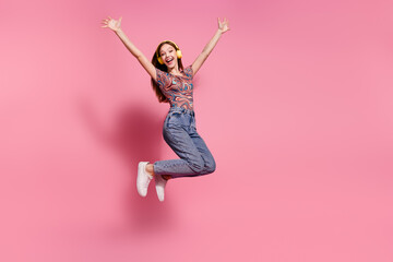 Full length photo of lovely teen lady jump raise hands headphones dressed stylish print clothes...