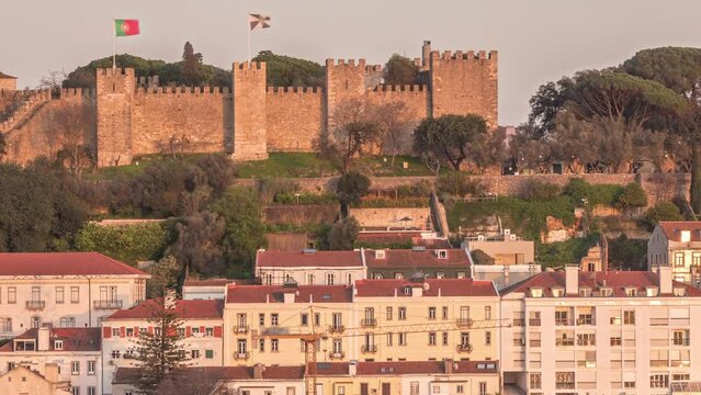 Castle Castelo de Sao Jorge Belevedere aerial timelapse from Miradoura de Sao Pedro de Alcantara viewpoint. Outlook over Lisbon during sunset with historic houses. Portugal