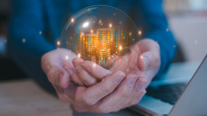investment and finance concept, businessman holding virtual trading graph and blurred coins in bubble on hand, stock market, profits and business growth