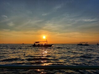 sailing boat with sunrise in the background