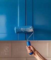 renovation old cabinet in the kitchen by painting it blue with a paint roller