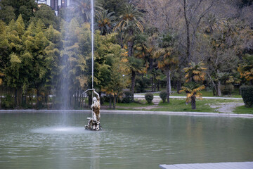 View on working fountain Sagittarius against tropical foliage in the Primorski Park or Prince of...