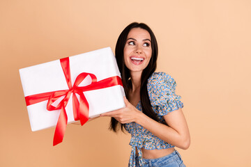 Photo of stunning lovely cheerful woman wear blue stylish clothes hold big gift look empty space...