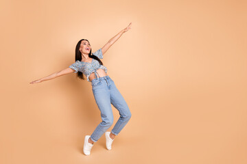 Photo of cheerful pretty lovely woman dressed blue stylish outfit look empty space isolated on beige background