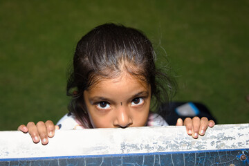 Portrait of a little girl looking at the camera in the park