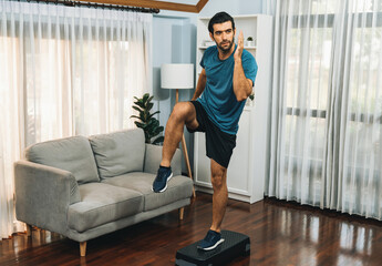 Athletic and sporty man running posture at home body workout exercise session for fit physique and healthy sport lifestyle at home. Gaiety home exercise workout training.