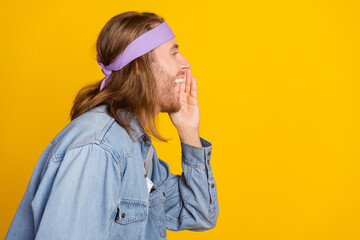 Photo portrait of attractive young hippie man profile announce scream wear trendy denim outfit isolated on yellow color background