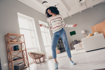 Photo of cheerful positive lady dressed striped pullover having fun dancing indoors apartment room