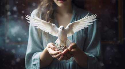 A beautiful white pigeon with wings in a woman's hands
