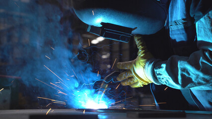 Close up view a worker welding the  product. Cinematic view of welding.