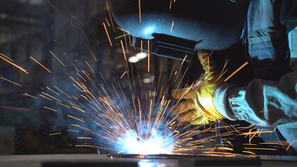 Close up view a worker welding the  product. Cinematic view of welding.