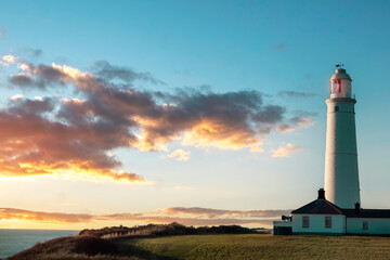 white lighthouse standing at coast of Wales the North Sea at sunrise, United Kingdom