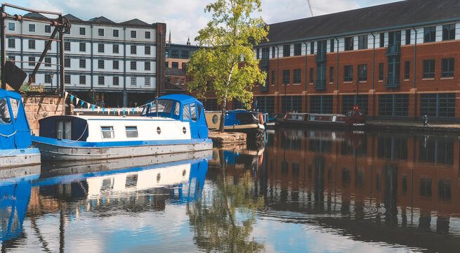 discovering hidden treasures of old English city.  Magnificent view of canal quays with long boats on  calm day