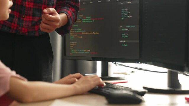 Slow motion back end or software developer manager supervising his team on new application program development on debugging and solving complex code algorithms on monitor. Burgeoning