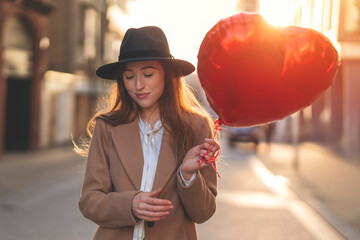 smiling woman with heart-shaped balloon falling in love walking around city  Lifestyle, birthday...