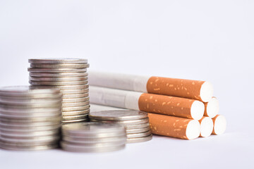 Cigarettes and TAX concept. Smoking is a waste of money. Cigarettes.Tobacco Cigarettes and money coins.