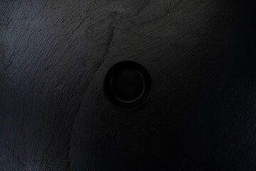 Black bowl on a textured dark background