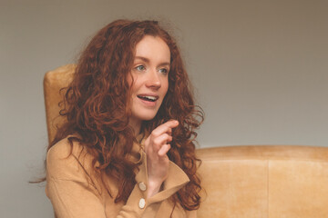 excited redhead woman secretly eating sweets, sitting on floor at home Dieting, addicted concept