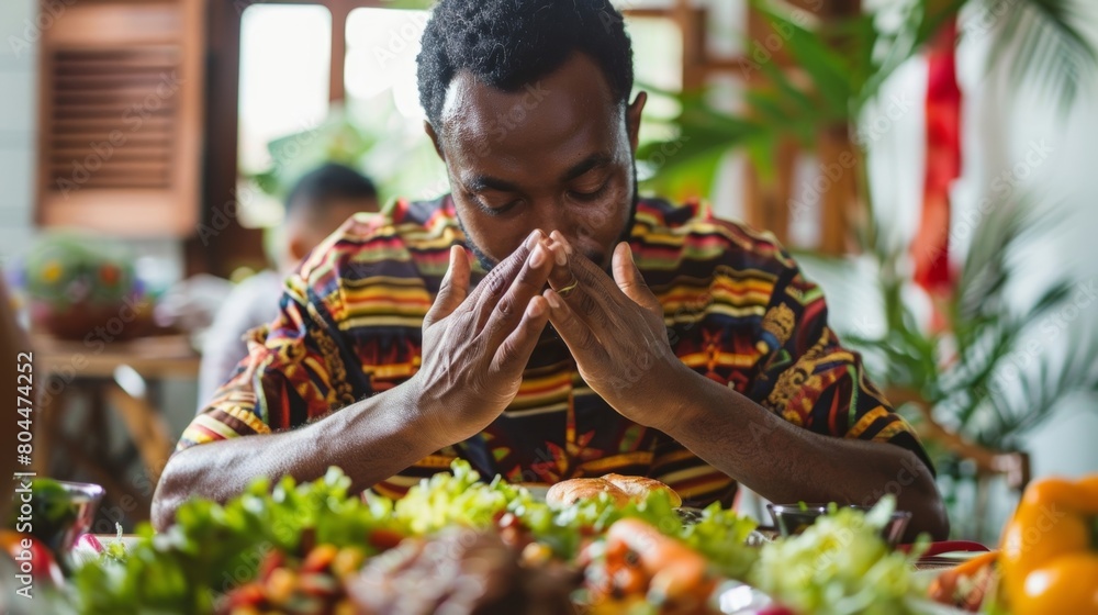 Poster a man practices gratitude before each meal taking a moment to acknowledge the effort and resources t