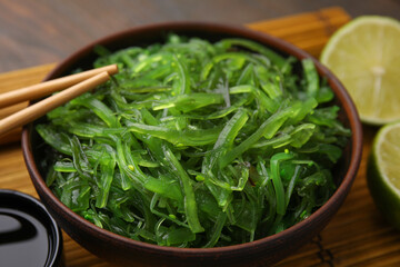 Tasty seaweed salad in bowl served on table, closeup © New Africa