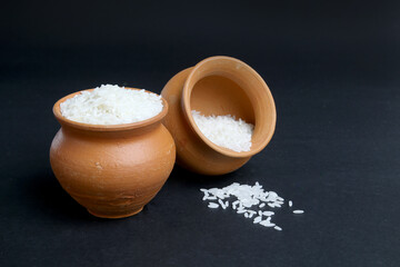 rice grains in the clay pot. traditional mud pot vessel to preserve or cook rice.