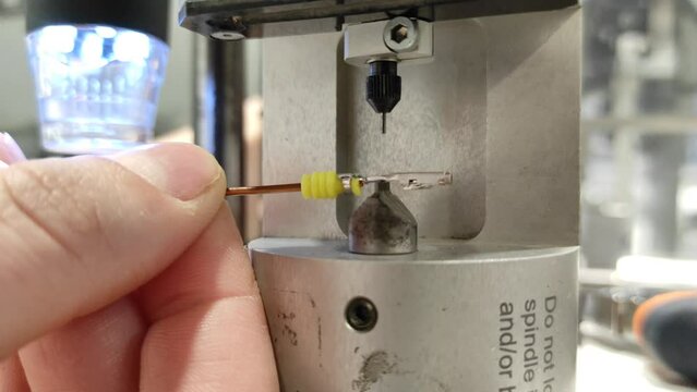 Measurement with an industrial automatic micrometer. Automobile production. Production of automotive electrical wiring