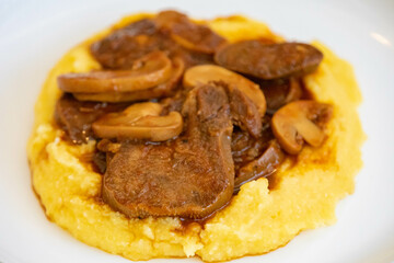 Traditional beef tongue in Madeira sauce with polenta. Brazilian rustic dish