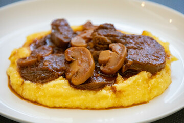 Traditional beef tongue in Madeira sauce with polenta. Brazilian rustic dish