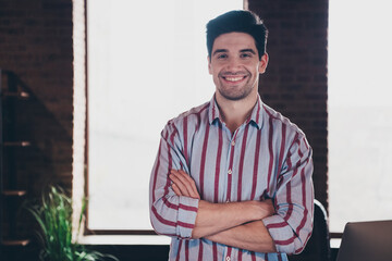 Photo of young man corporate worker crossed arms wear striped shirt modern office home indoors