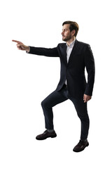 Man in a suit striking a pointing pose, photographed in a studio on a white background, portraying...
