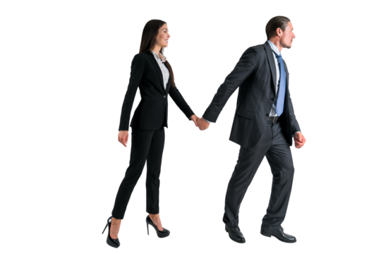 Two professionals in business attire walking hand in hand, isolated on a white background, depicting partnership