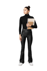 A woman standing with a notebook, wearing a black turtleneck and leather pants, against a white background, model pose concept