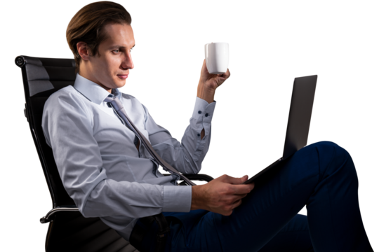 A businessman in a chair holding a mug and using a laptop, on an isolated white background, depicting a work concept