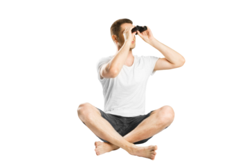 A man sitting cross-legged and looking through binoculars, isolated on a white background, depicting concept of search or discovery