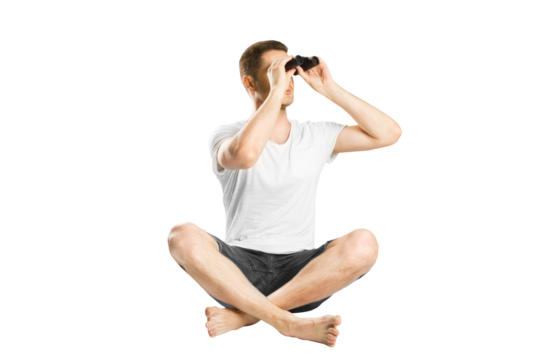A man sitting cross-legged and looking through binoculars, isolated on a white background, depicting concept of search or discovery