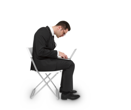 A man in a business suit seated on a chair working on a laptop, isolated on a white background, concept of professional work