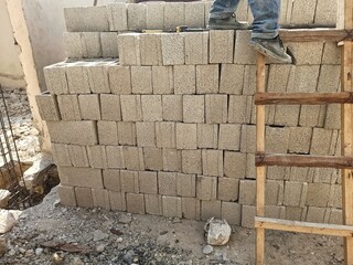 Building Fundamentals: Concrete Blocks and Wooden Ladder