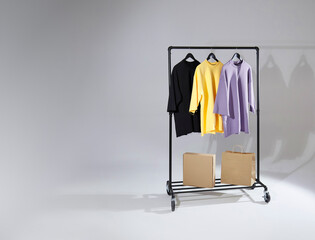 Men's t-shirts on rack hanger with paper bags. Men's clothing template for design presentation.