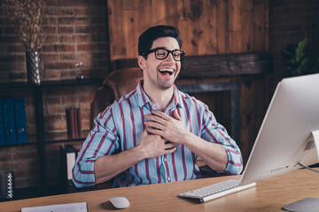 Portrait of nice young man laugh video call wear striped shirt loft interior business center indoors