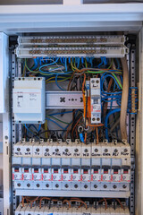 An electrician works on a fuse box