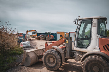 there is a large excavator and containers on a large building site